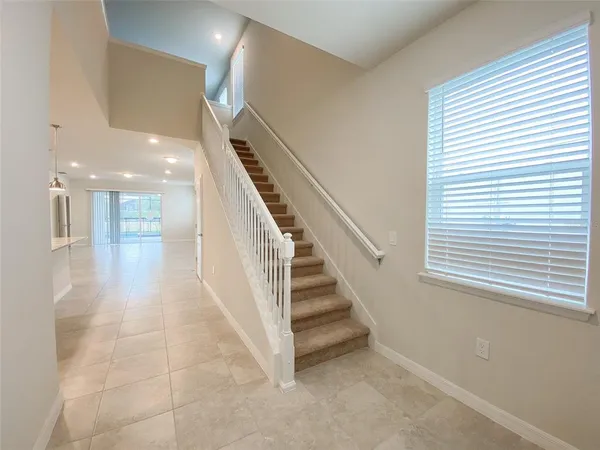 a kitchen with stainless steel appliances kitchen island granite countertop a refrigerator and a stove top oven