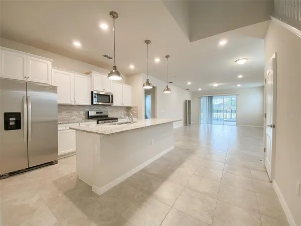 a kitchen with stainless steel appliances kitchen island granite countertop a sink and cabinets