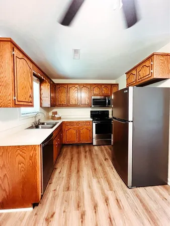 a kitchen with granite countertop stainless steel appliances a refrigerator and a sink