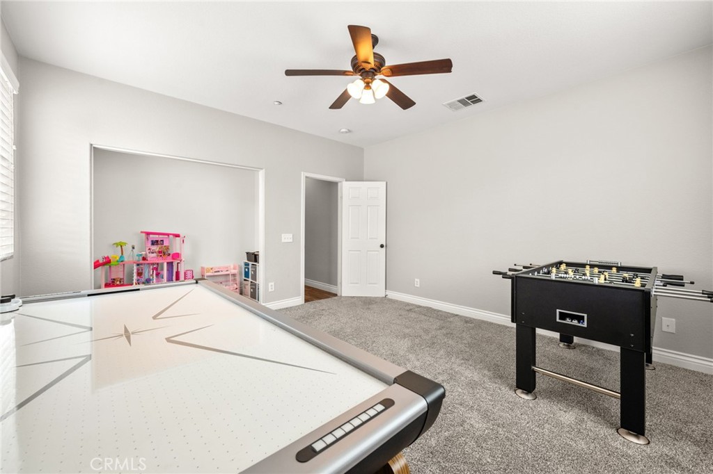 19791 Paso Robles Drive Riverside, CA 92508 - Photo 11 of 29 a bedroom with a bed and a chandelier