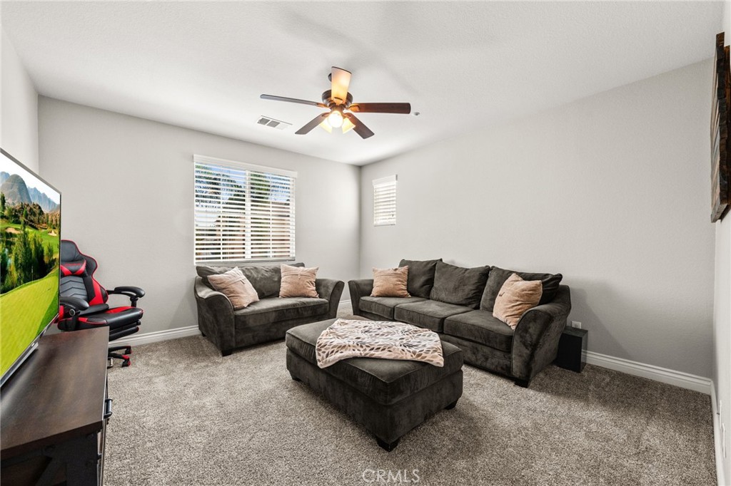 19791 Paso Robles Drive Riverside, CA 92508 - Photo 12 of 29 a living room with furniture and a flat screen tv
