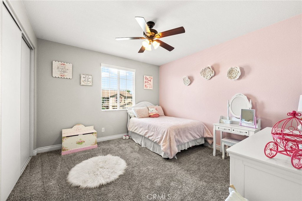 19791 Paso Robles Drive Riverside, CA 92508 - Photo 17 of 29 a bedroom with a bed and a chandelier