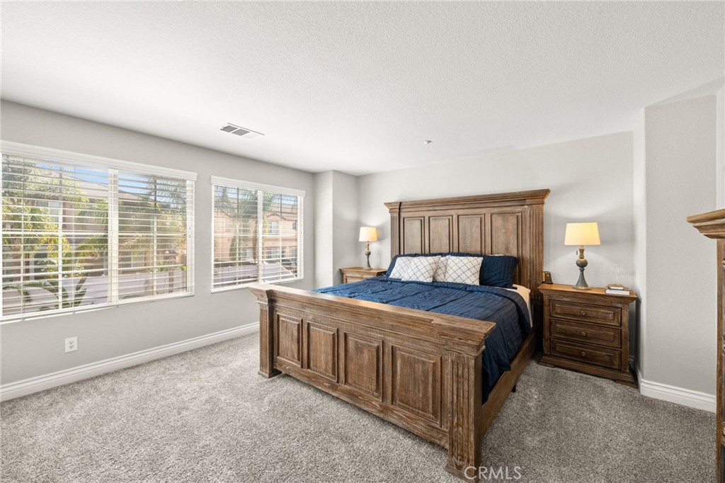 19791 Paso Robles Drive Riverside, CA 92508 - Photo 20 of 29 a bedroom with a bed couch and a large window