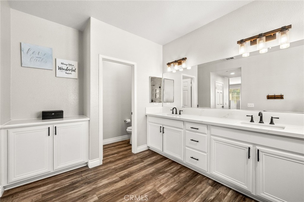 19791 Paso Robles Drive Riverside, CA 92508 - Photo 25 of 29 a spacious bathroom with a double vanity sink and mirror