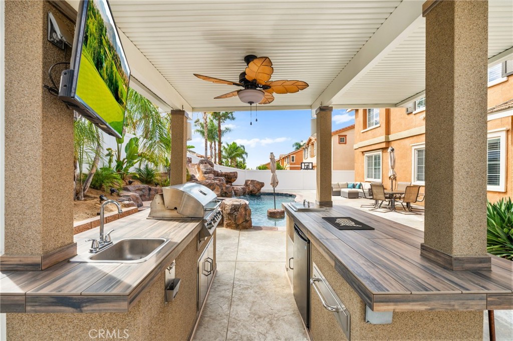 19791 Paso Robles Drive Riverside, CA 92508 - Photo 27 of 29 a kitchen view with stove a sink and living room view