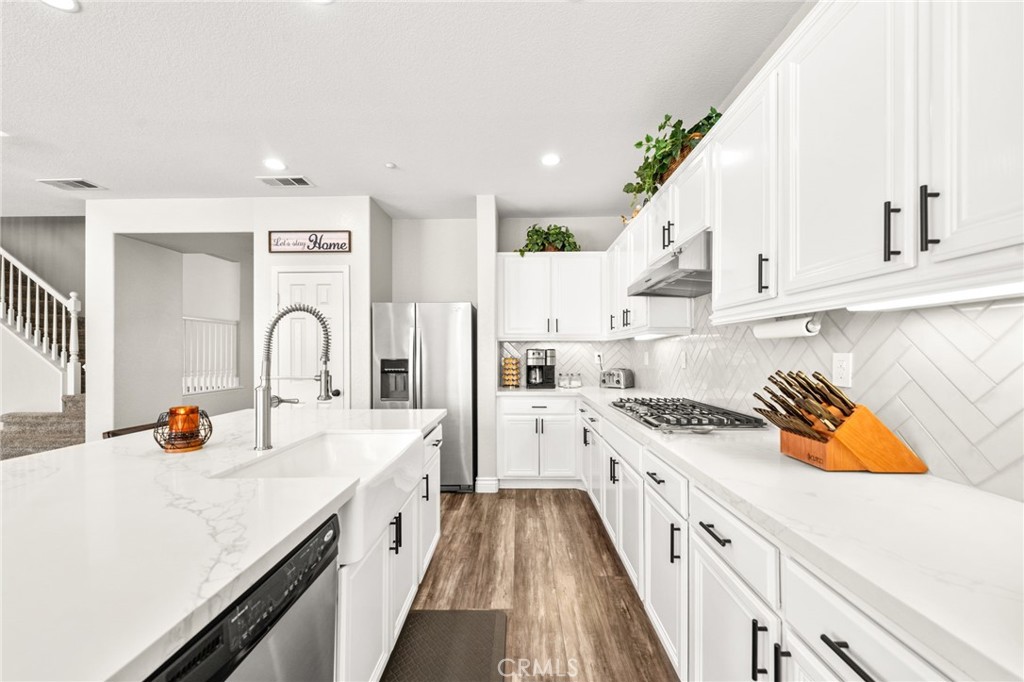 19791 Paso Robles Drive Riverside, CA 92508 - Photo 7 of 29 a kitchen with a sink a stove and cabinets