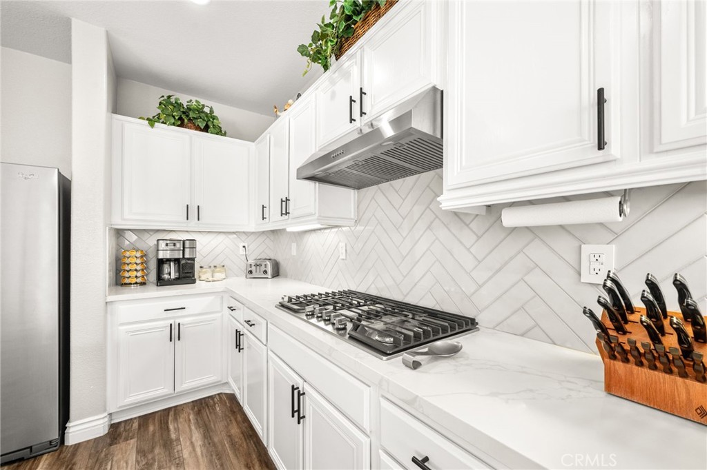 19791 Paso Robles Drive Riverside, CA 92508 - Photo 8 of 29 a kitchen with stainless steel appliances a white stove top oven and white cabinets