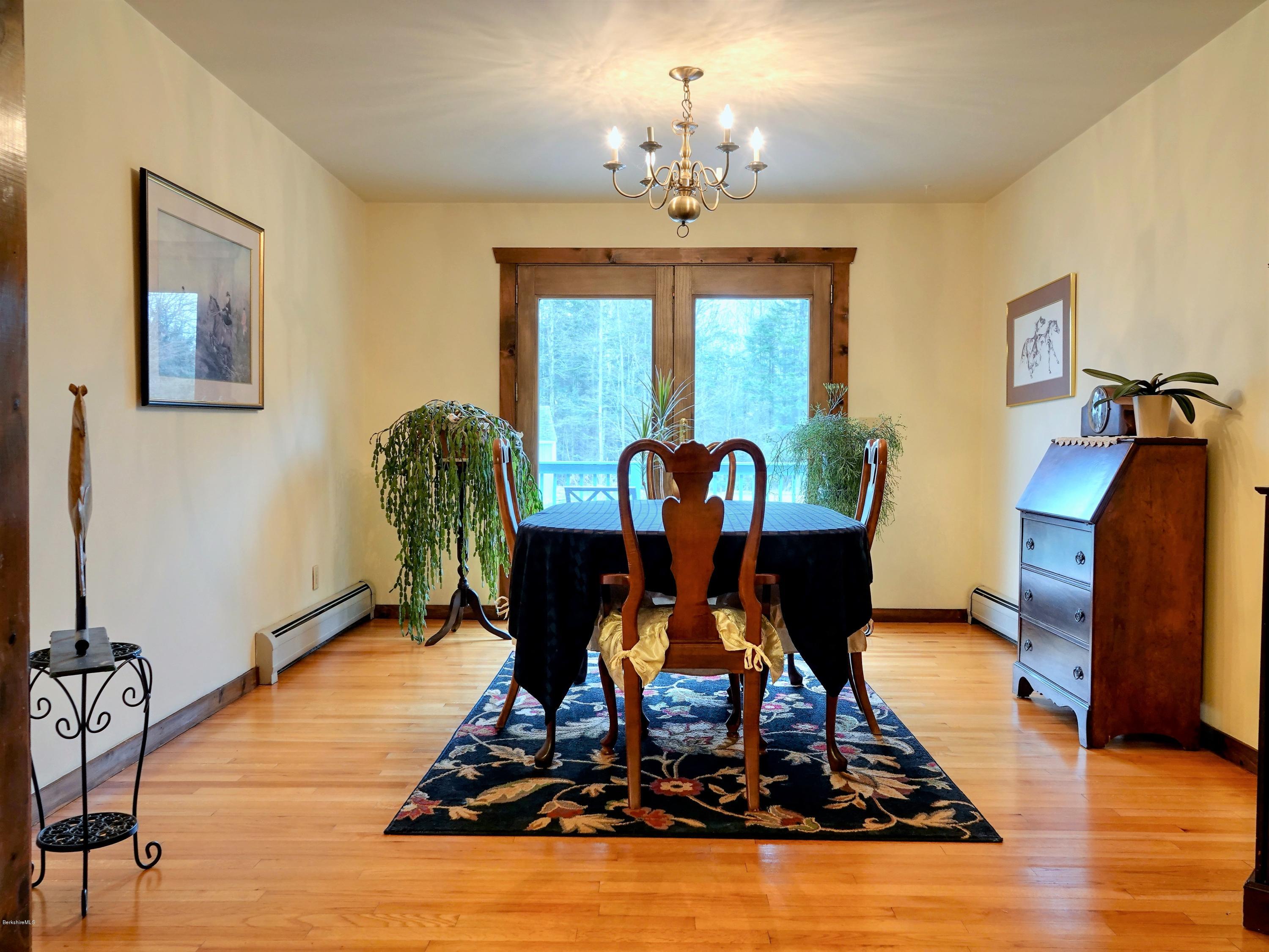 25 Groll Road Heath, MA 01346 - Photo 9 of 23 a view of a dining room with furniture a chandelier and wooden floor