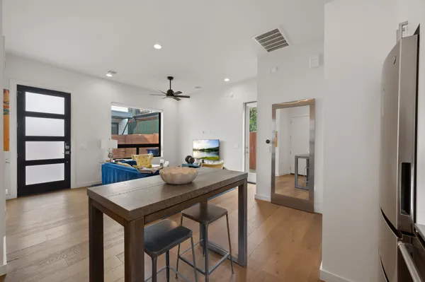 a view of a dining room with furniture and wooden floor