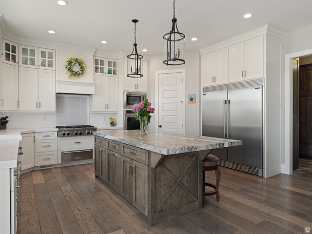 641 West 500 South Midway, UT 84049 - Photo 13 of 52 Gourmet kitchen featuring white cabinetry, stainless steel appliances, a range hood, and a large wood-finish island with a stone countertop