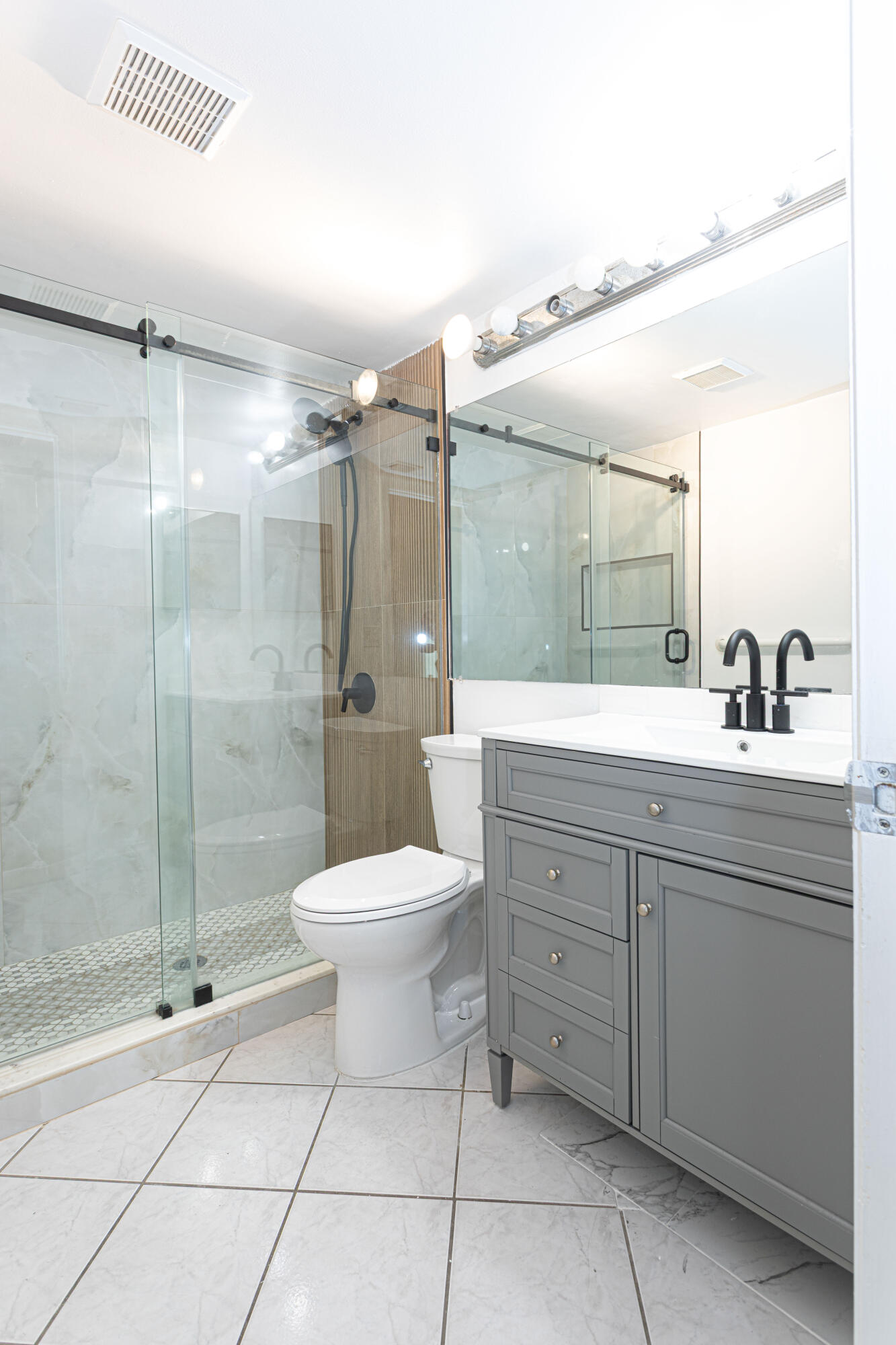 603 Sea Pine Way, Unit C1 Greenacres, FL 33415 - Photo 15 of 32 a bathroom with a toilet sink and shower