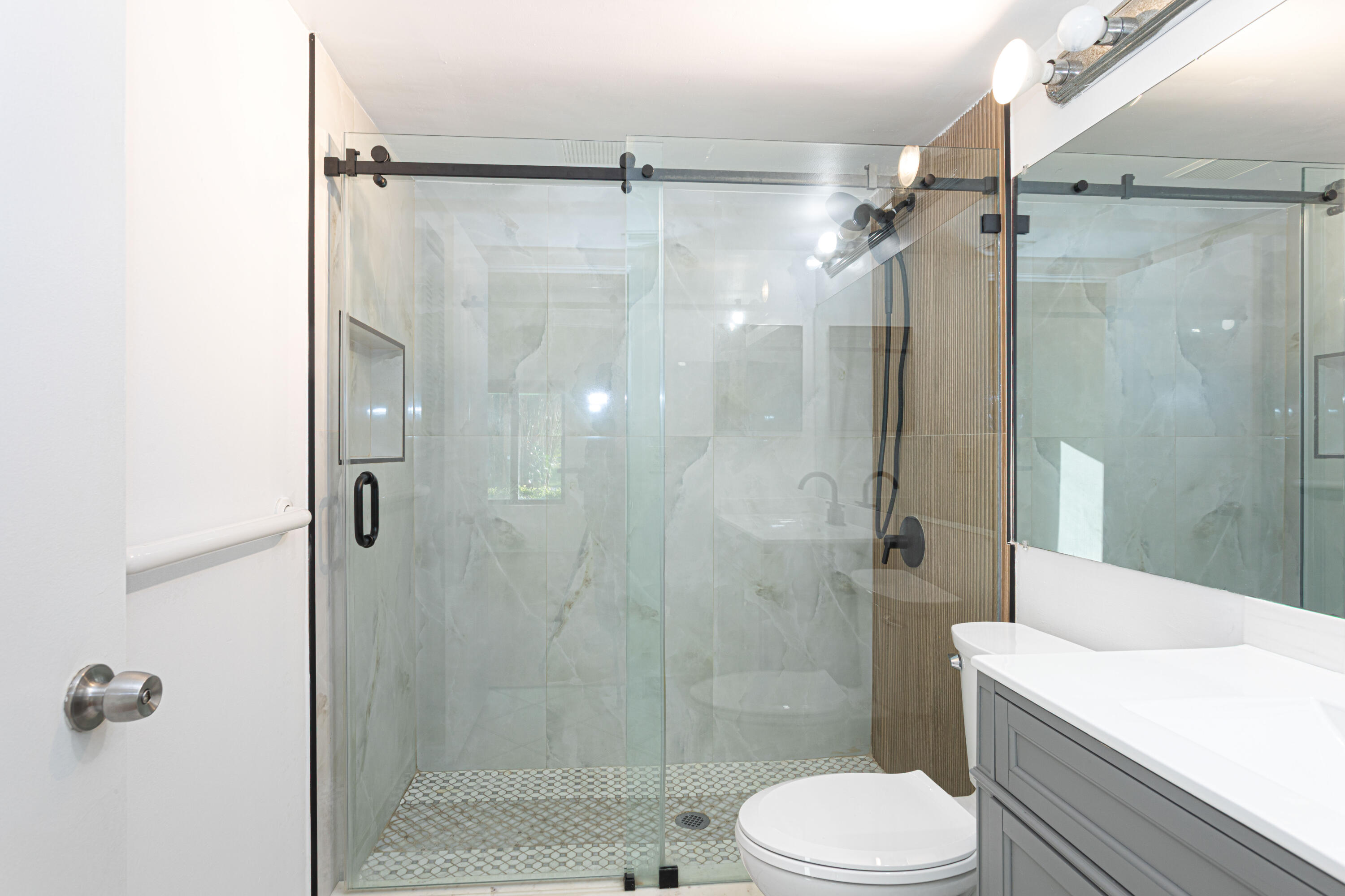 603 Sea Pine Way, Unit C1 Greenacres, FL 33415 - Photo 16 of 32 a bathroom with a shower a toilet and a sink