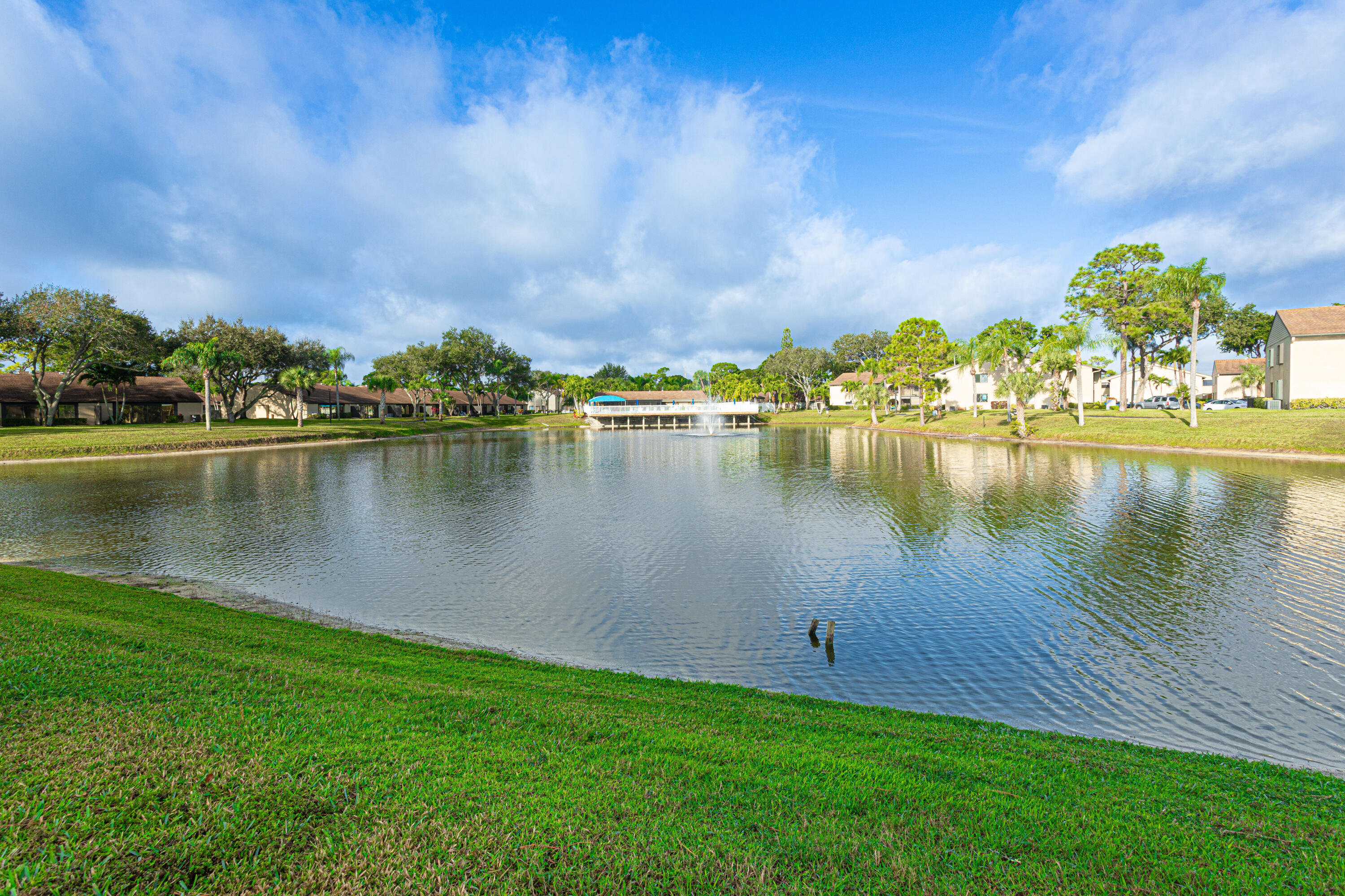 603 Sea Pine Way, Unit C1 Greenacres, FL 33415 - Photo 31 of 32 a view of a lake with houses in the back