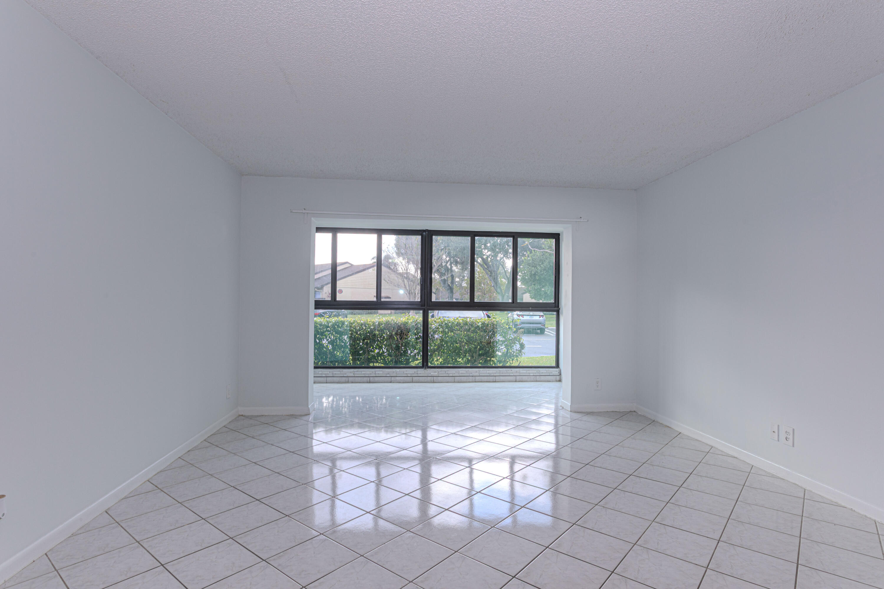 603 Sea Pine Way, Unit C1 Greenacres, FL 33415 - Photo 4 of 32 a view of an empty room with a window