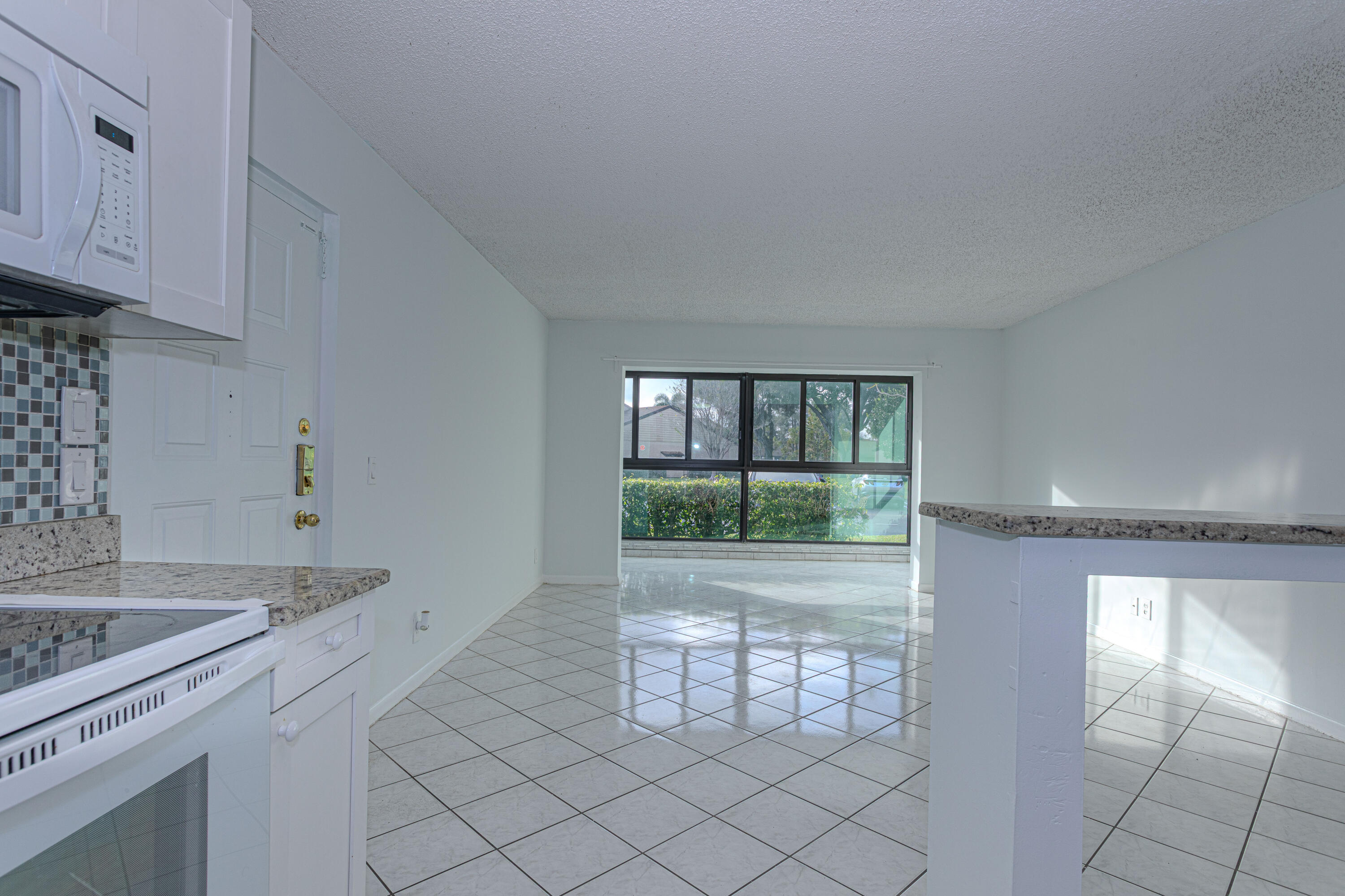 603 Sea Pine Way, Unit C1 Greenacres, FL 33415 - Photo 6 of 32 a kitchen with a sink and cabinets