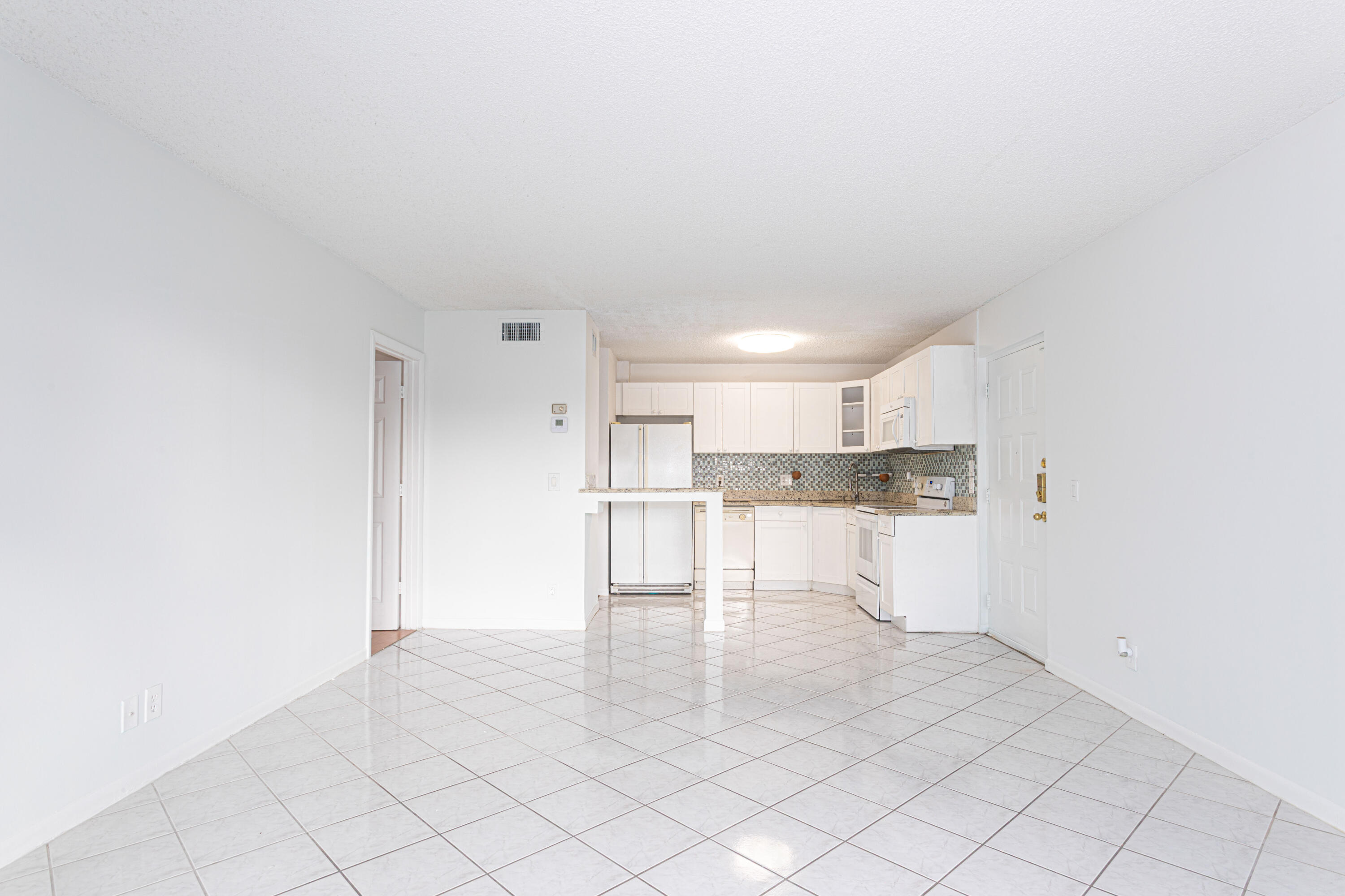 603 Sea Pine Way, Unit C1 Greenacres, FL 33415 - Photo 7 of 32 a view of a kitchen with white cabinets