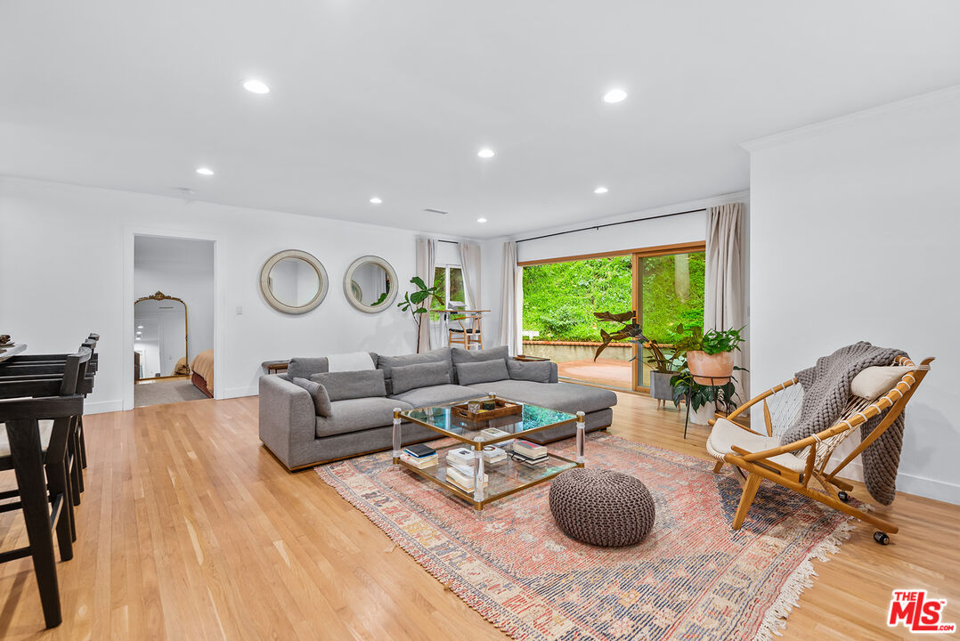 2621 Mandeville Canyon Road Los Angeles, CA 90049 - Photo 1 of 30 a living room with furniture a large window and a table
