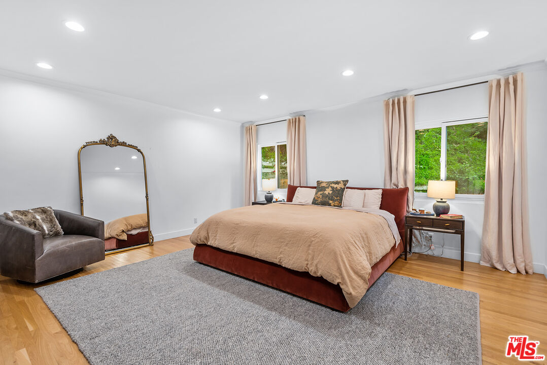 2621 Mandeville Canyon Road Los Angeles, CA 90049 - Photo 11 of 30 a bedroom with a bed and window