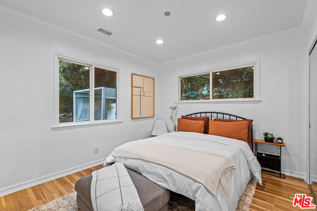 2621 Mandeville Canyon Road Los Angeles, CA 90049 - Photo 15 of 30 a bedroom with a large bed and a window