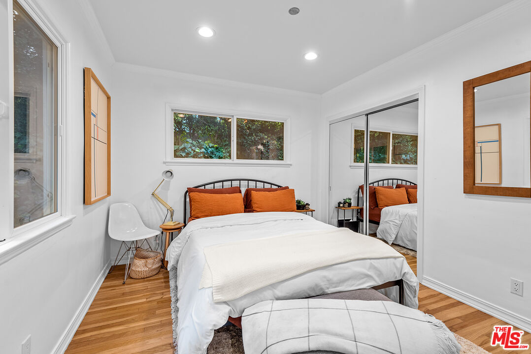 2621 Mandeville Canyon Road Los Angeles, CA 90049 - Photo 16 of 30 a bedroom with a bed and dresser with mirror