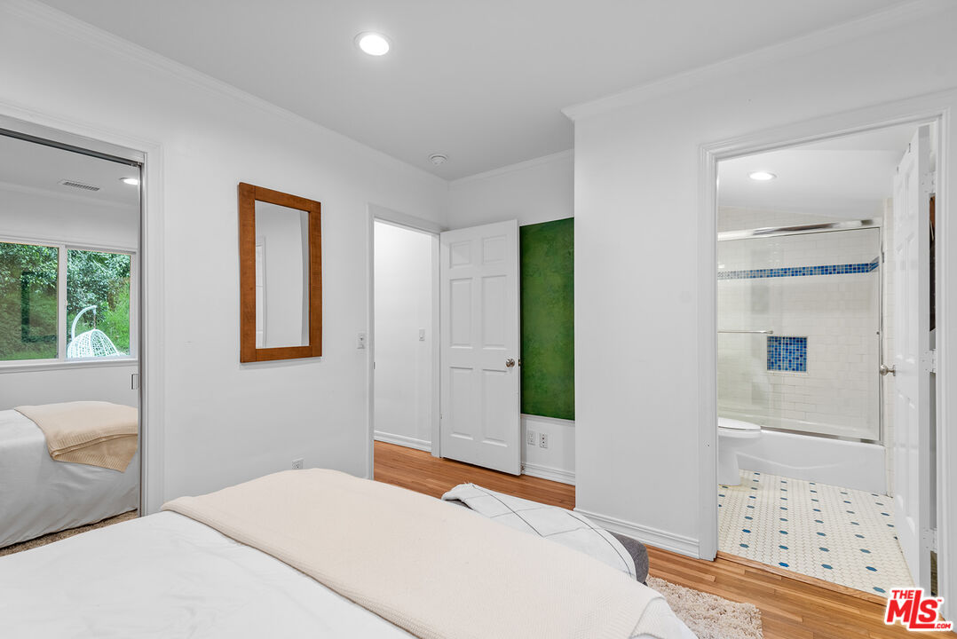 2621 Mandeville Canyon Road Los Angeles, CA 90049 - Photo 17 of 30 a bedroom with a bed and a window