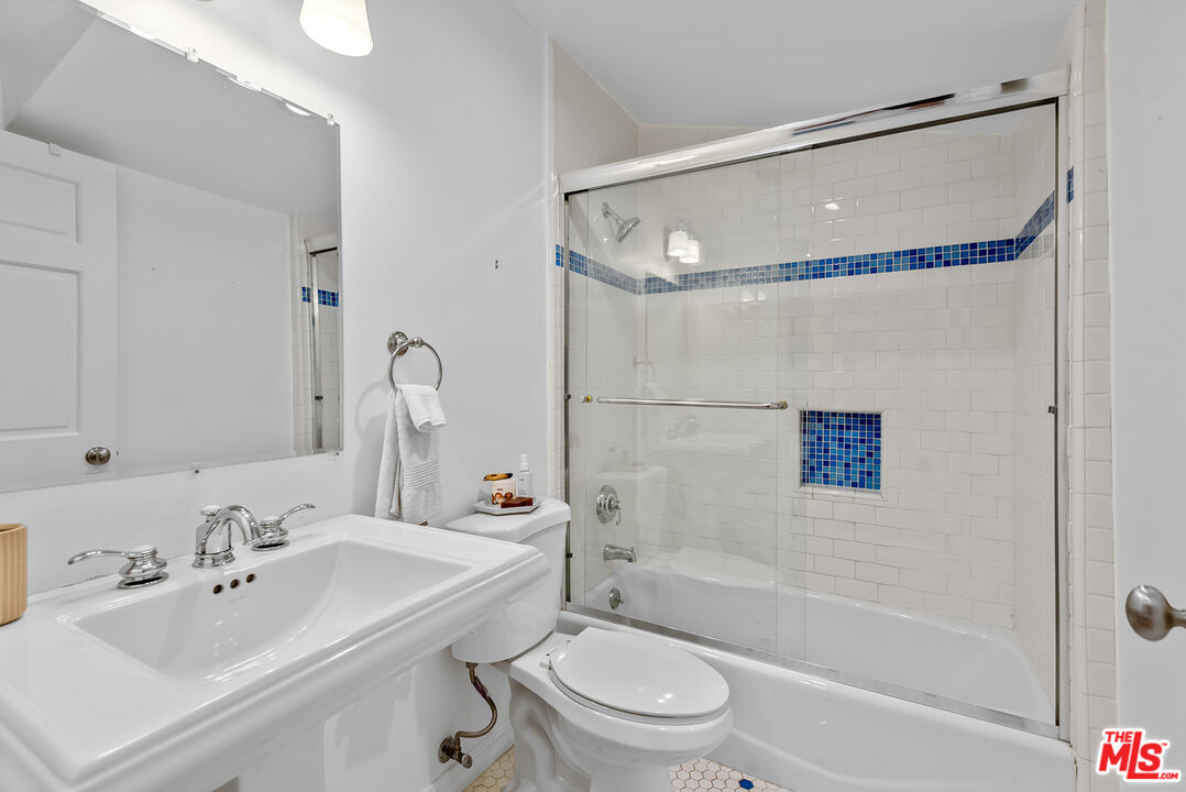 2621 Mandeville Canyon Road Los Angeles, CA 90049 - Photo 18 of 30 a bathroom with a sink toilet tub and shower