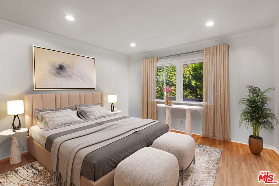 2621 Mandeville Canyon Road Los Angeles, CA 90049 - Photo 19 of 30 a bedroom with bed and a large window
