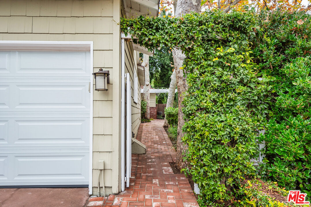 2621 Mandeville Canyon Road Los Angeles, CA 90049 - Photo 2 of 30 a view of a pathway of a house with a yard