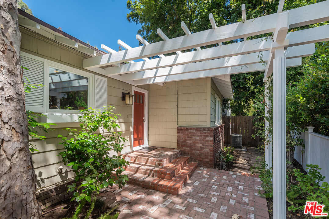 2621 Mandeville Canyon Road Los Angeles, CA 90049 - Photo 3 of 30 a front view of a house with garden
