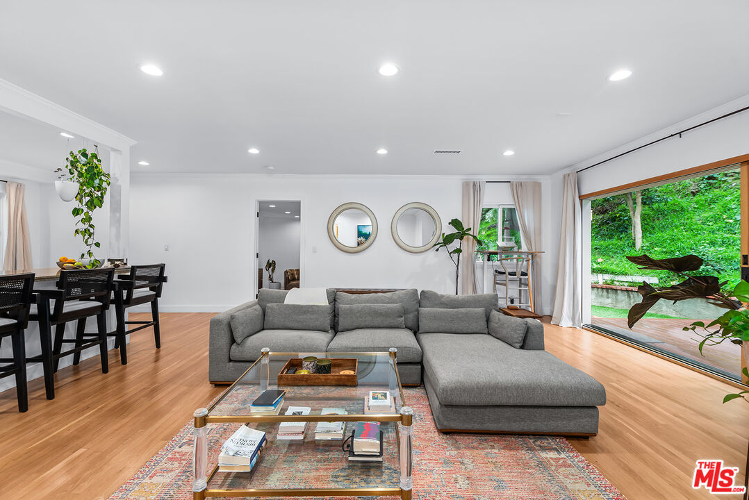 2621 Mandeville Canyon Road Los Angeles, CA 90049 - Photo 4 of 30 a living room with furniture and a large window