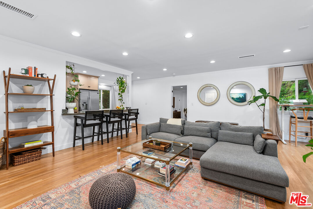 2621 Mandeville Canyon Road Los Angeles, CA 90049 - Photo 5 of 30 a living room with furniture and a wooden floor