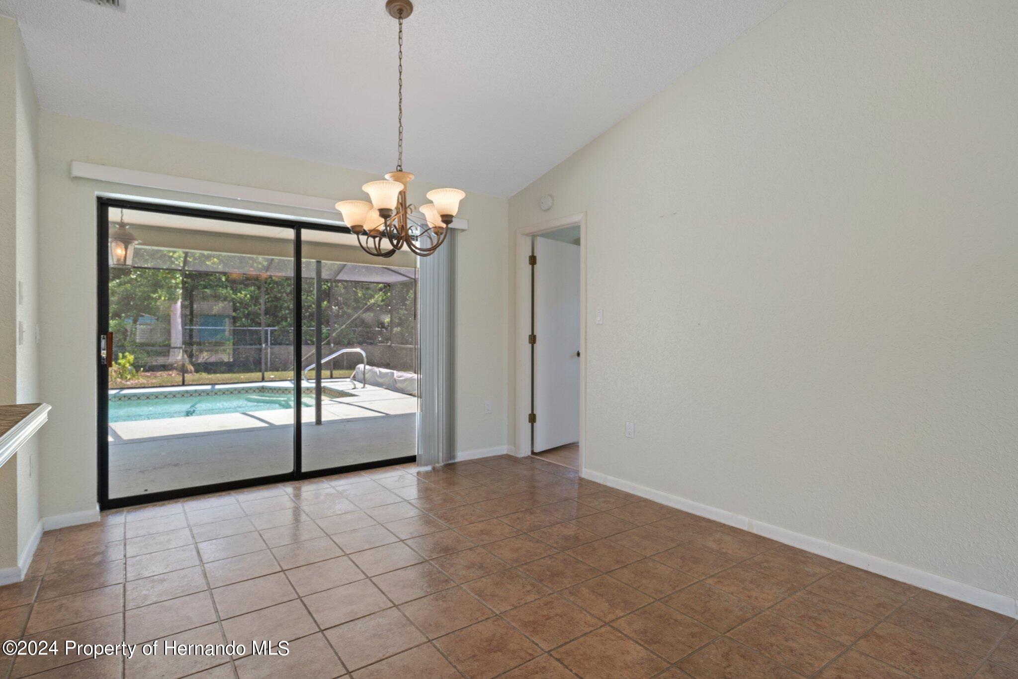 9290 Eldridge Road Spring Hill, FL 34608 - Photo 11 of 55 a view of a room with window and chandelier