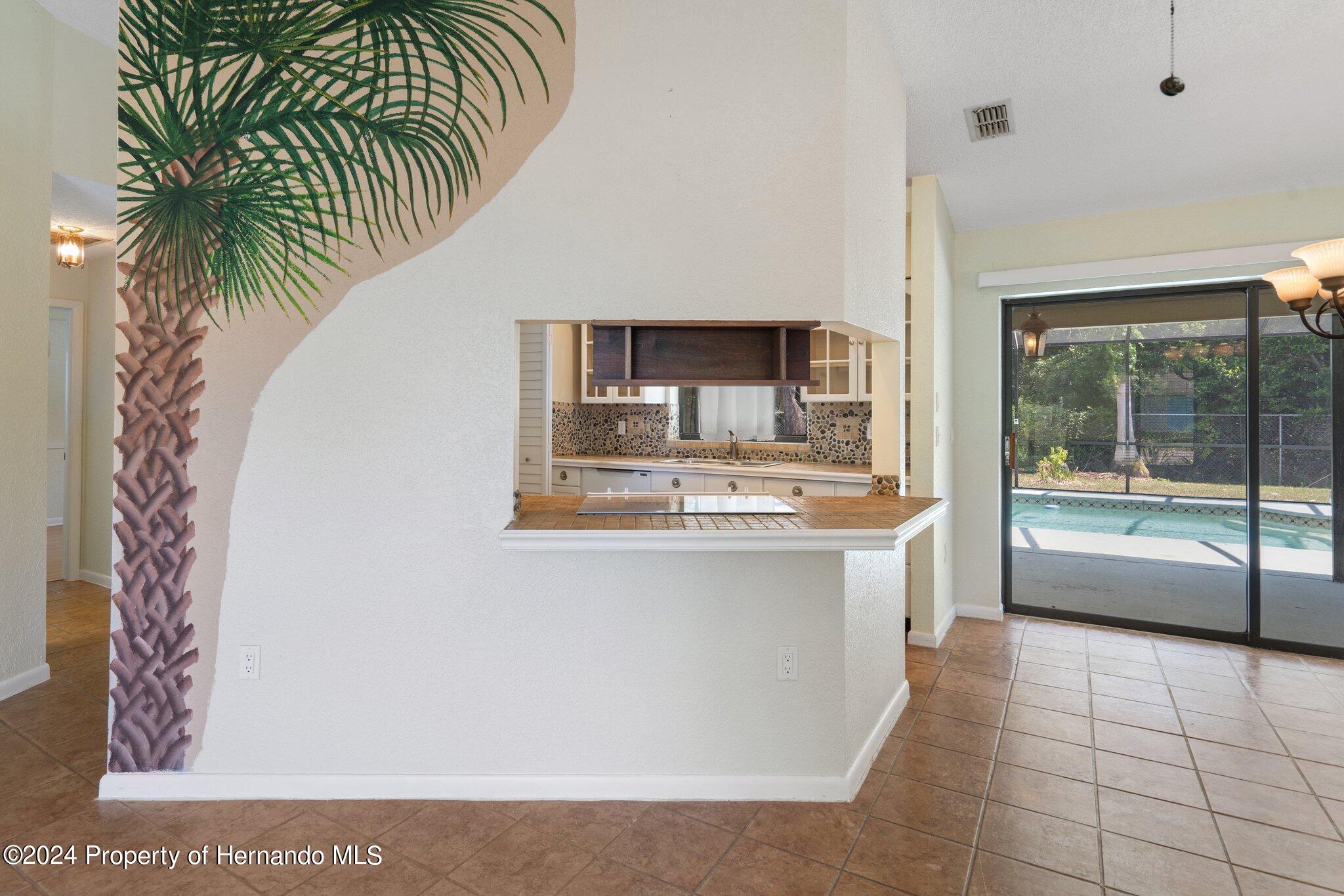 9290 Eldridge Road Spring Hill, FL 34608 - Photo 13 of 55 a large white kitchen with a large window