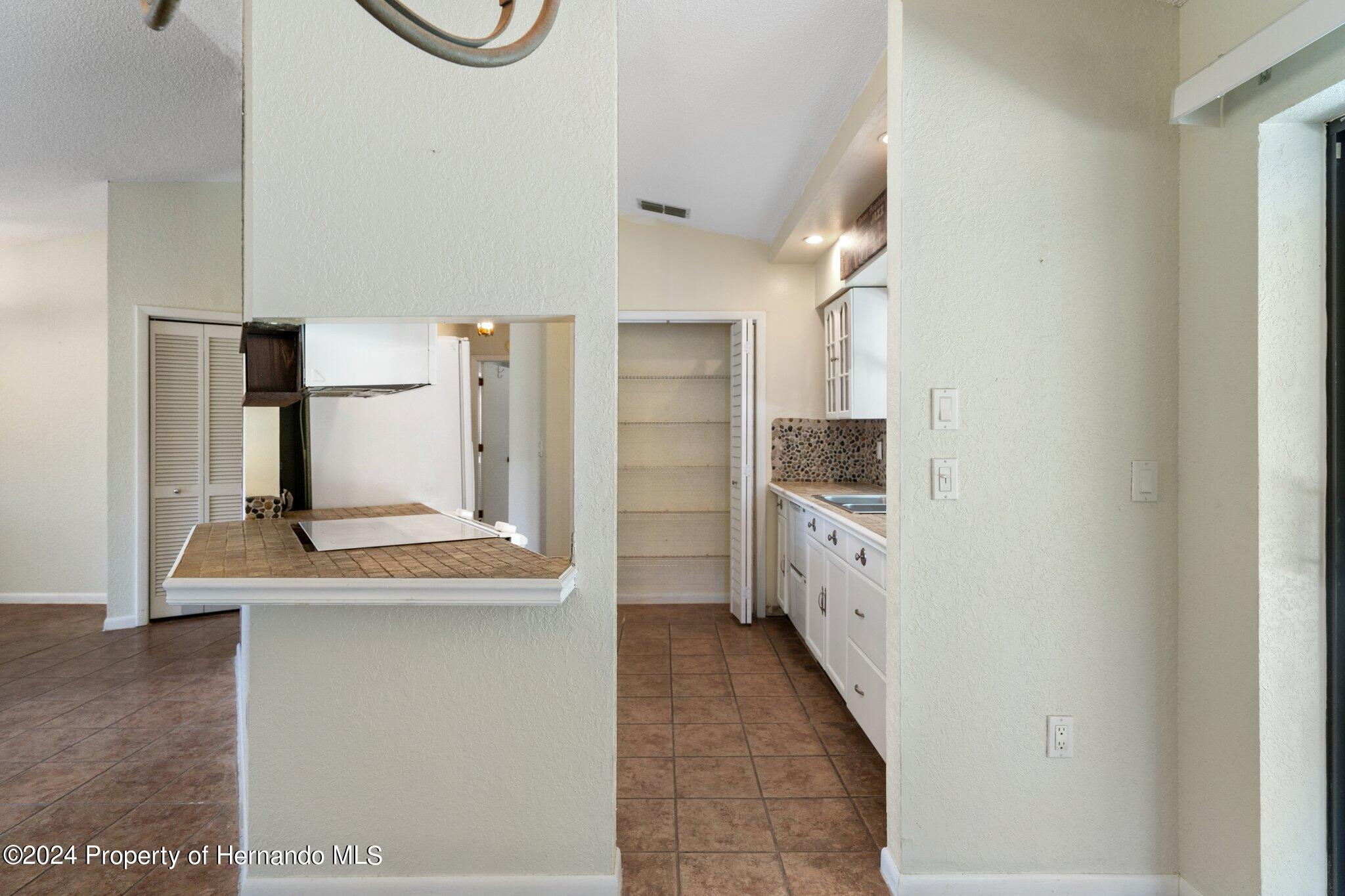 9290 Eldridge Road Spring Hill, FL 34608 - Photo 14 of 55 a view of a kitchen with refrigerator and a sink