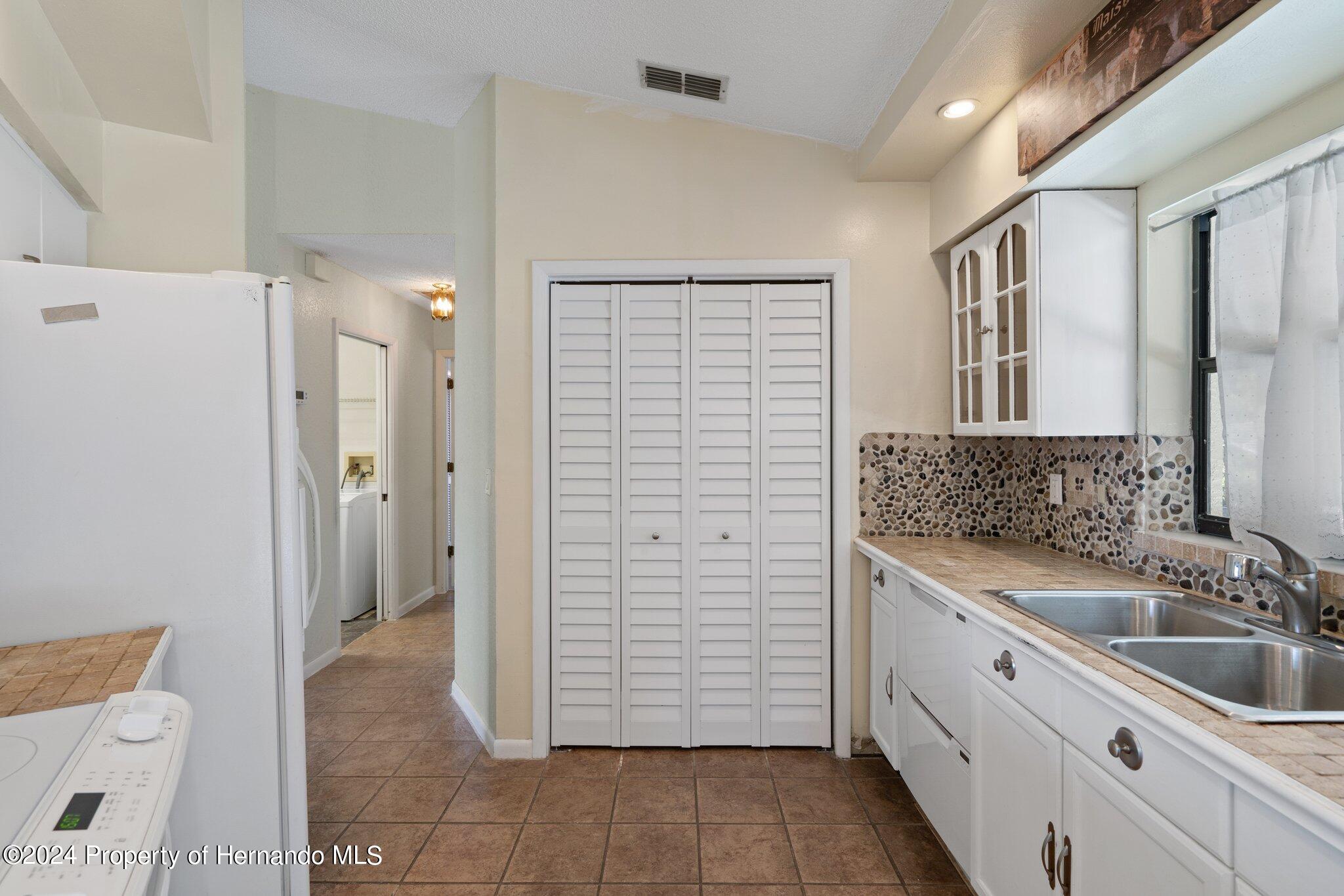 9290 Eldridge Road Spring Hill, FL 34608 - Photo 15 of 55 a bathroom with a sink a toilet and shower