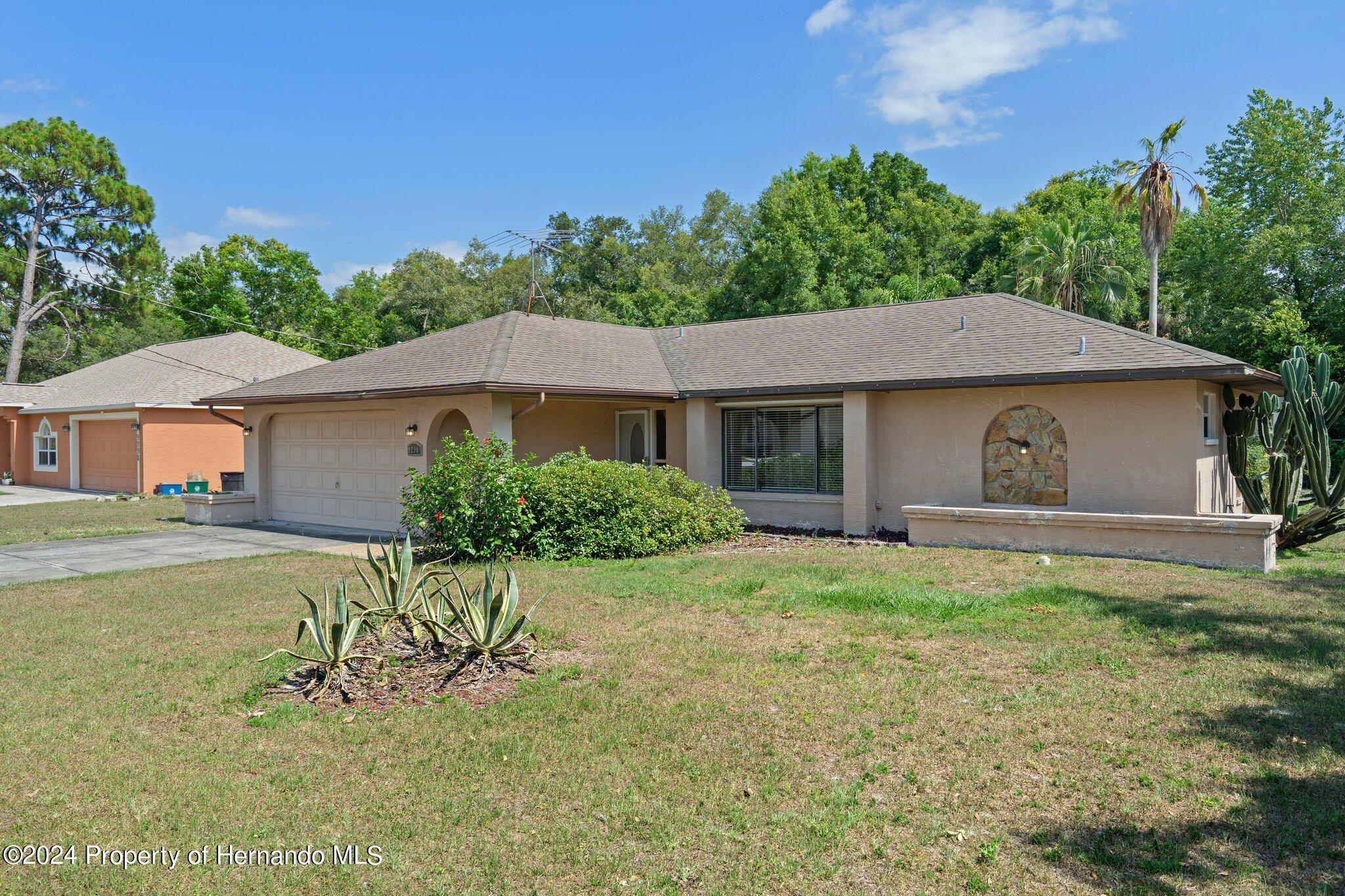 9290 Eldridge Road Spring Hill, FL 34608 - Photo 2 of 55 a house that has a tree in front of it