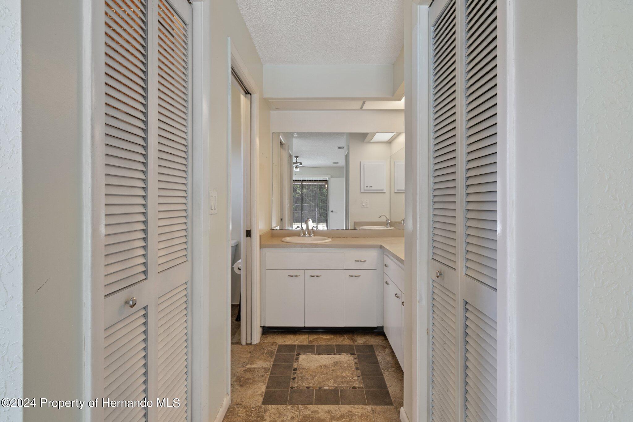 9290 Eldridge Road Spring Hill, FL 34608 - Photo 23 of 55 a bathroom with a sink and a mirror