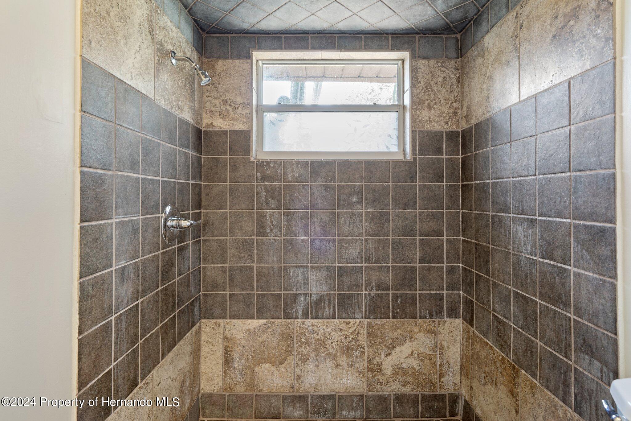 9290 Eldridge Road Spring Hill, FL 34608 - Photo 26 of 55 a bathroom with a shower