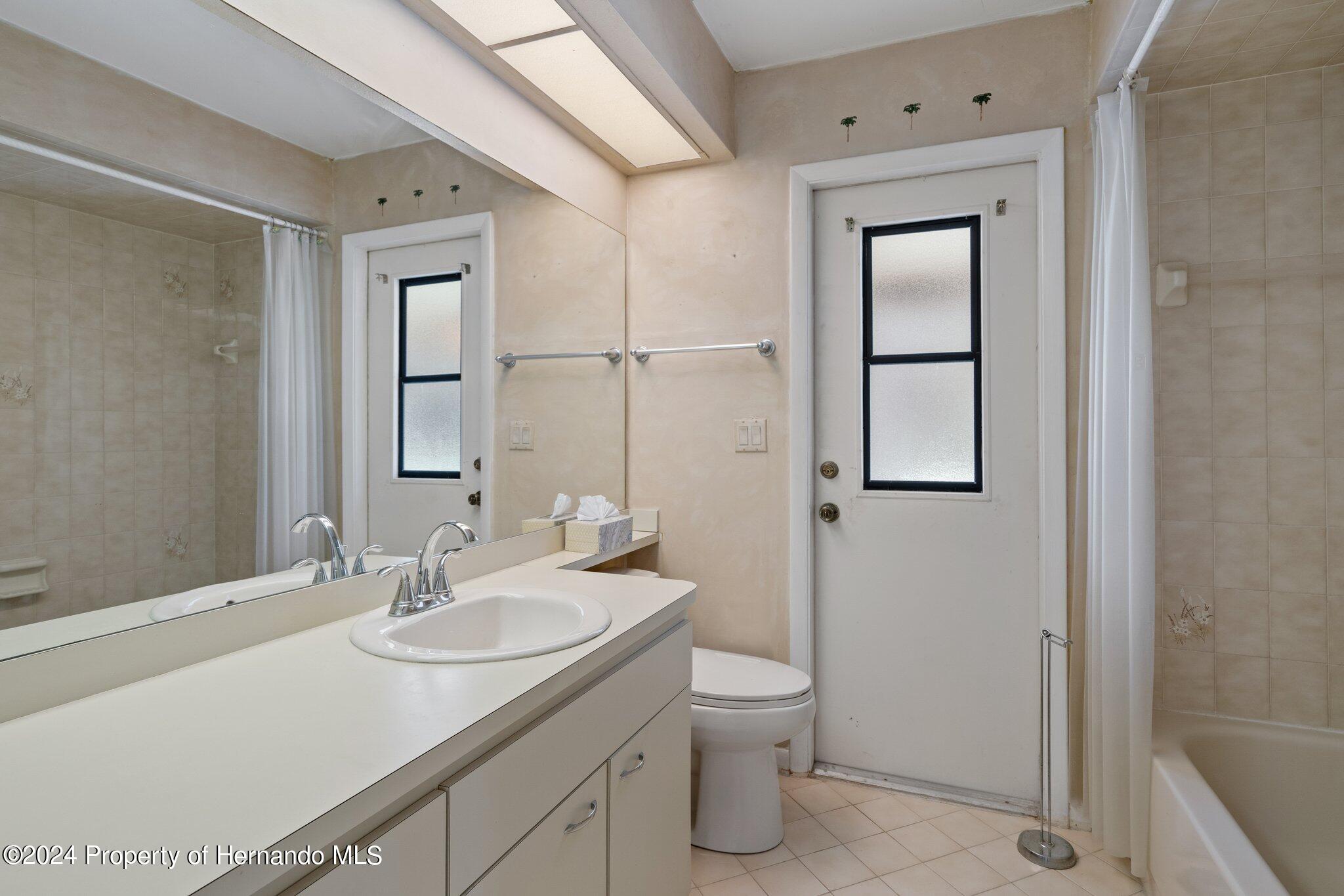 9290 Eldridge Road Spring Hill, FL 34608 - Photo 32 of 55 a bathroom with a sink toilet and shower