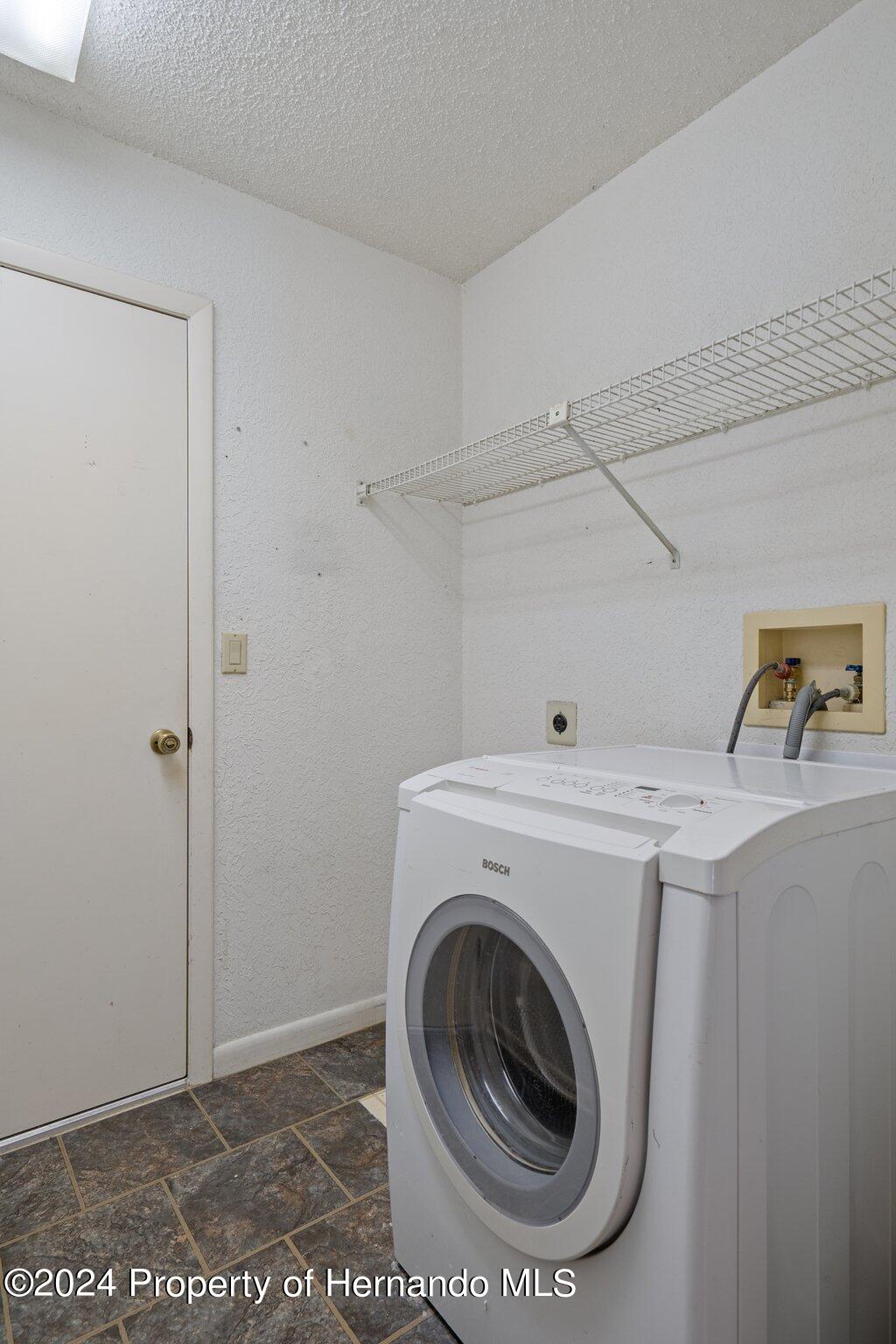 9290 Eldridge Road Spring Hill, FL 34608 - Photo 38 of 55 a utility room with dryer and washer