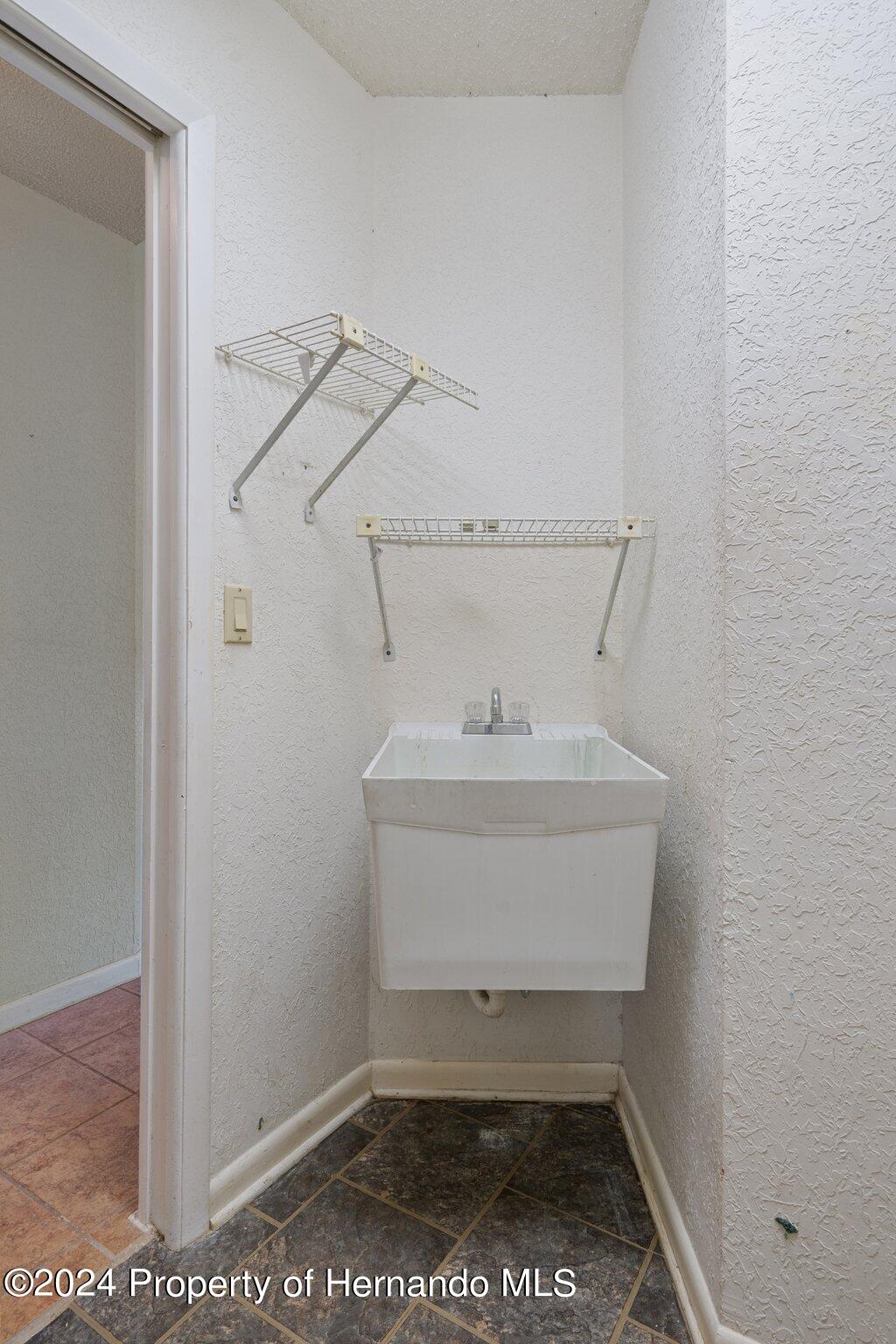 9290 Eldridge Road Spring Hill, FL 34608 - Photo 39 of 55 a bathroom with a sink and toilet