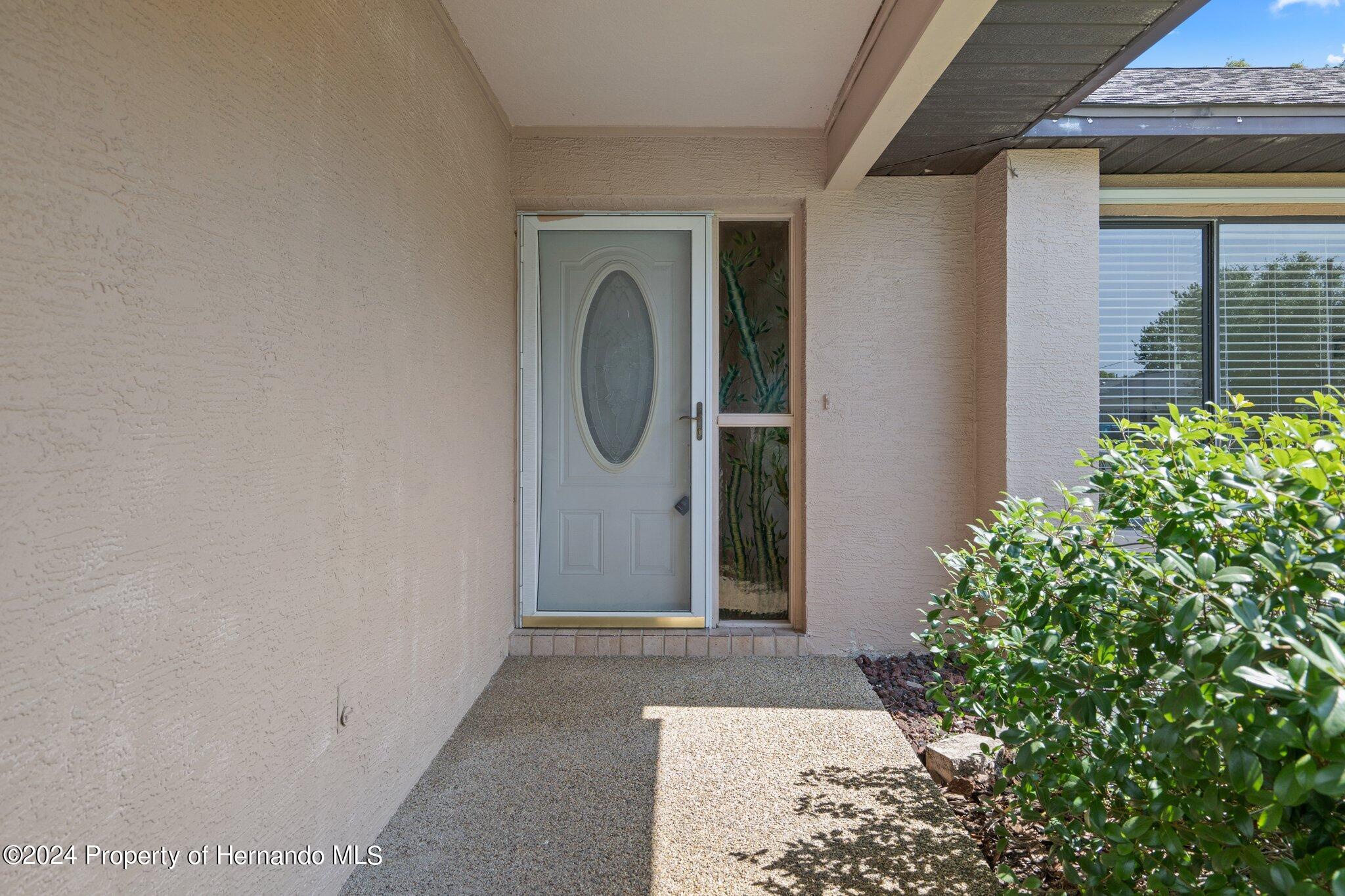 9290 Eldridge Road Spring Hill, FL 34608 - Photo 4 of 55 a view of a house with a door and a window