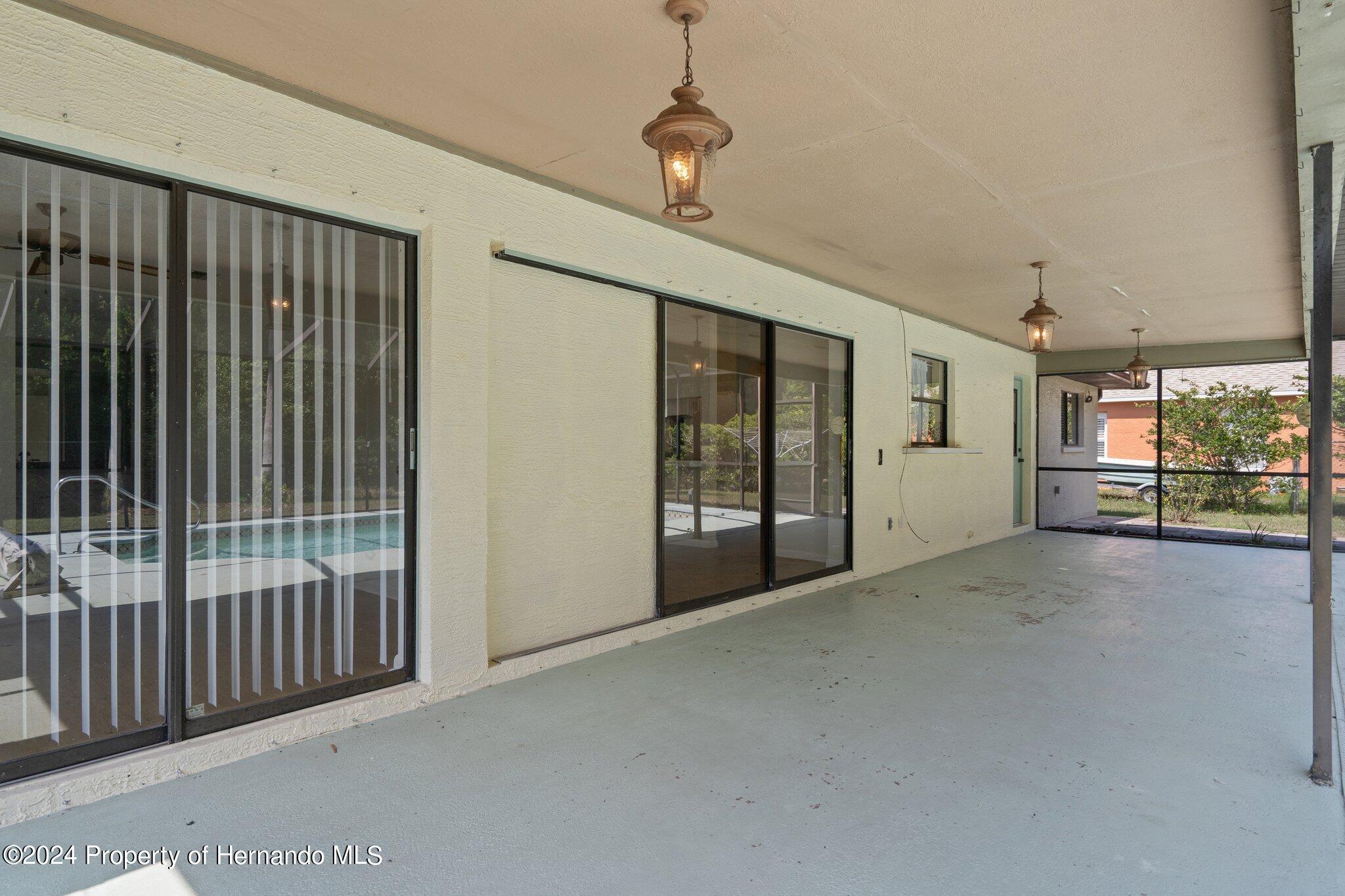 9290 Eldridge Road Spring Hill, FL 34608 - Photo 47 of 55 a view of empty room with floor to ceiling window