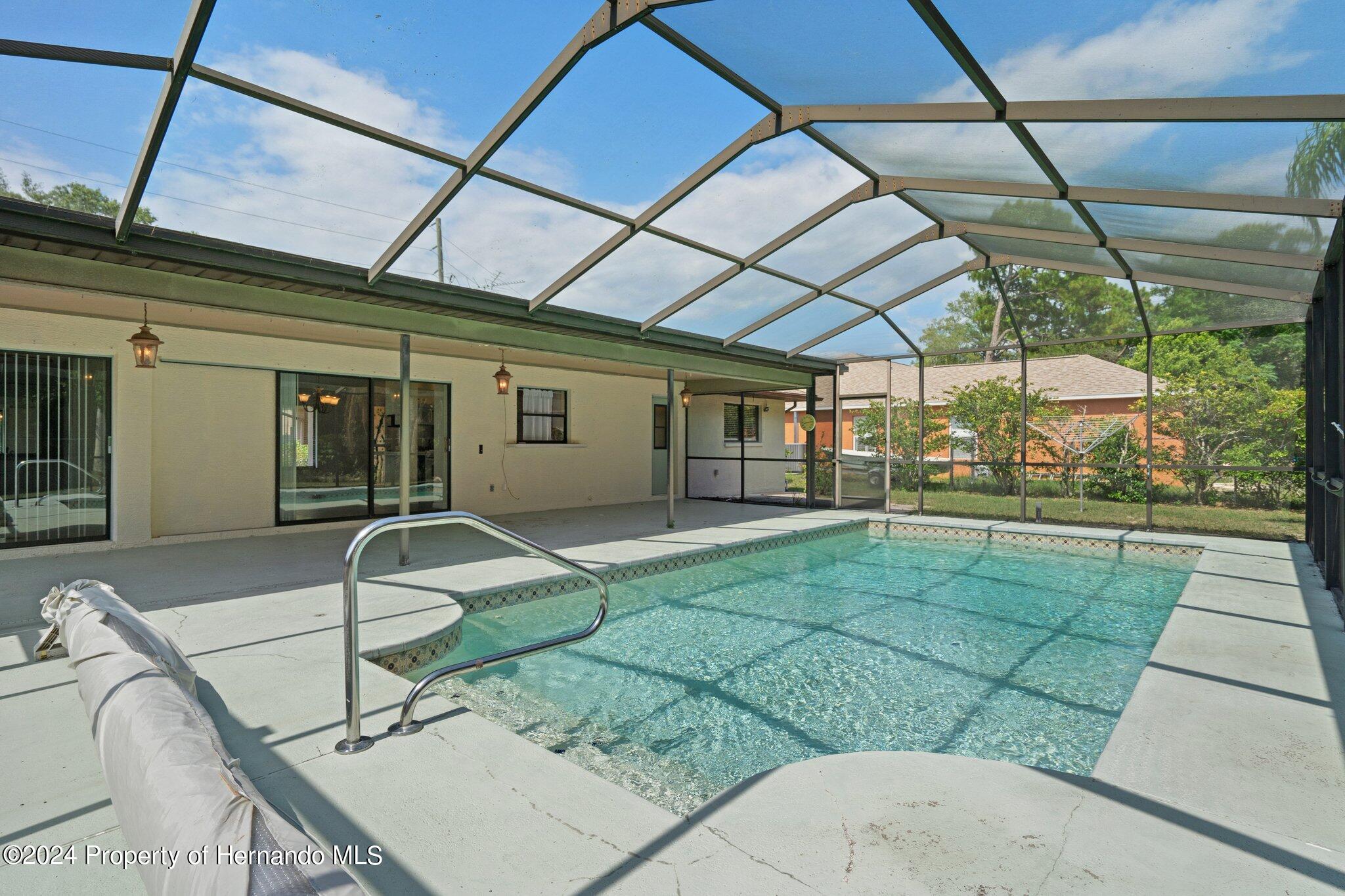 9290 Eldridge Road Spring Hill, FL 34608 - Photo 52 of 55 a house view with a sitting space and glass windows