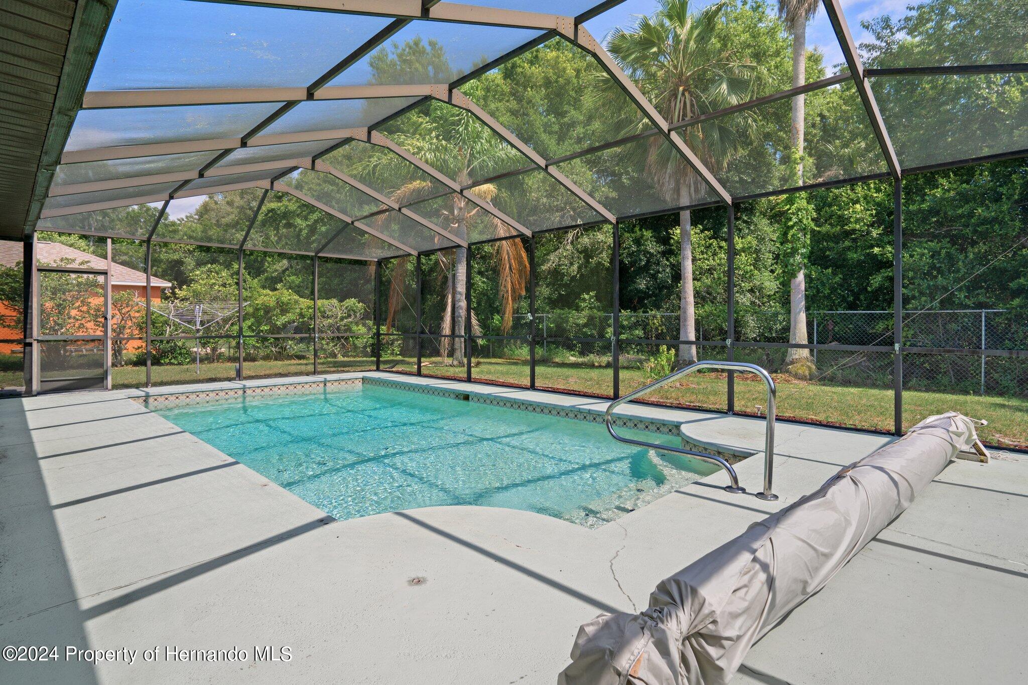 9290 Eldridge Road Spring Hill, FL 34608 - Photo 53 of 55 a view of a backyard with swimming pool