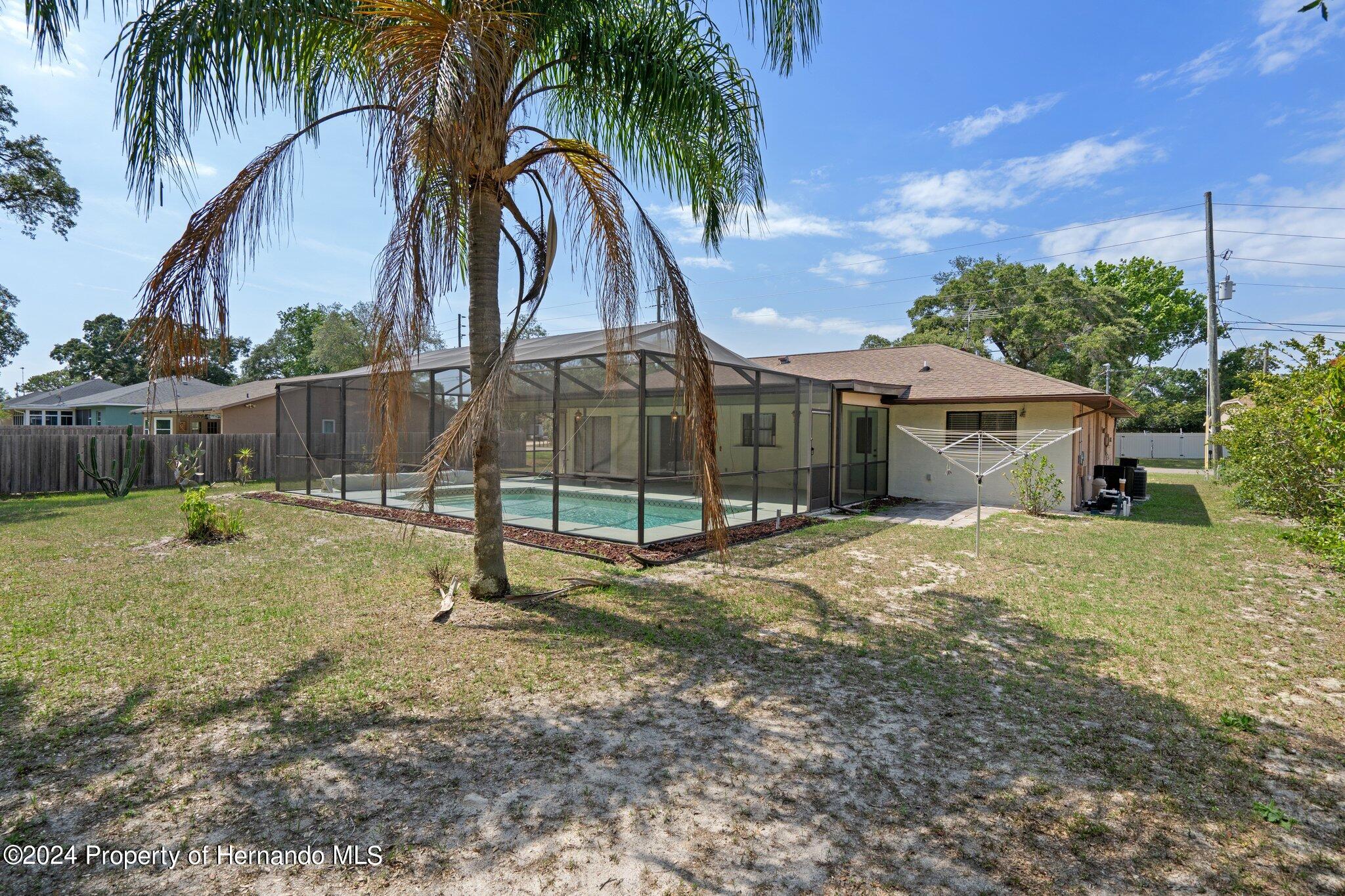 9290 Eldridge Road Spring Hill, FL 34608 - Photo 55 of 55 a view of a house with backyard and a slide