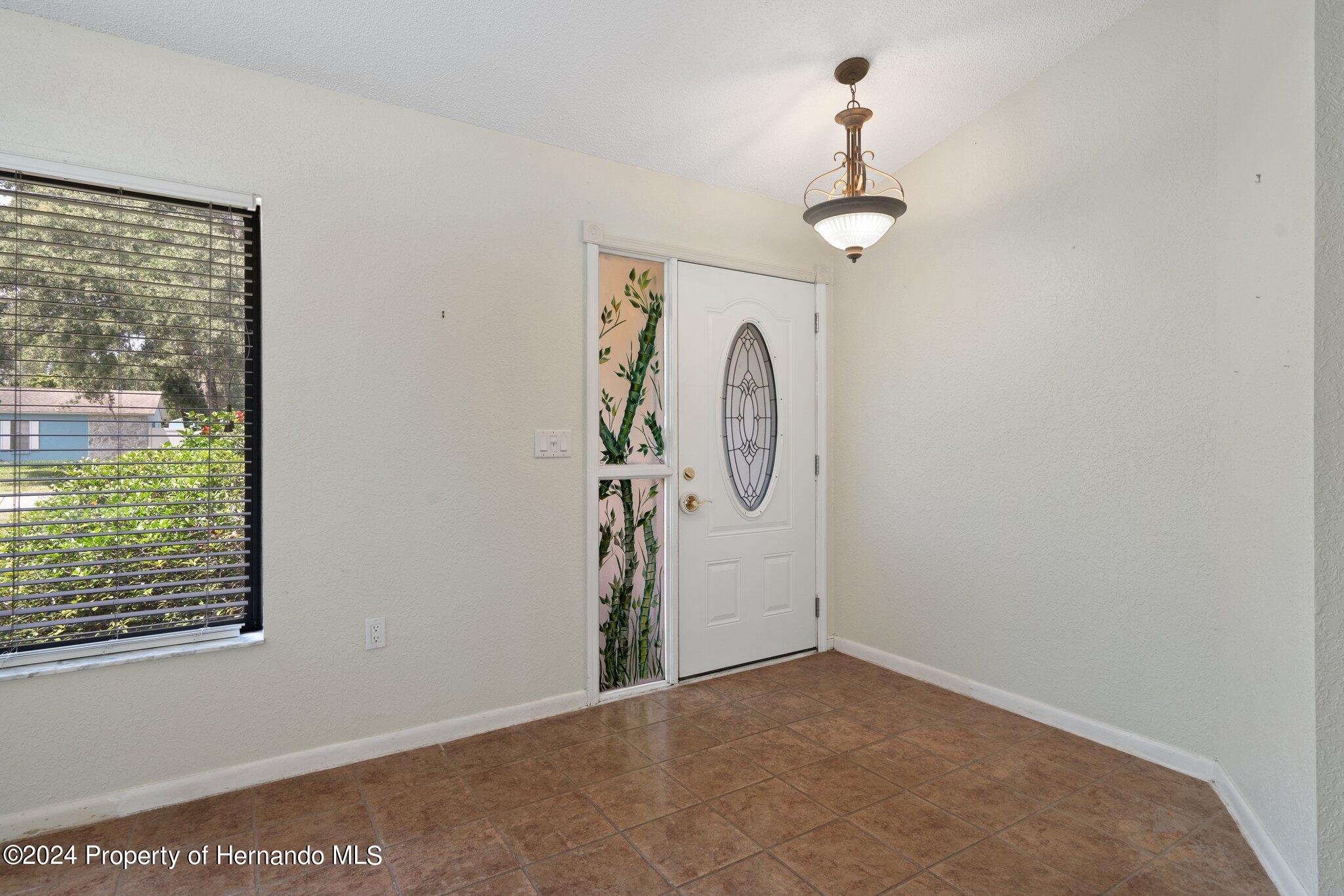 9290 Eldridge Road Spring Hill, FL 34608 - Photo 6 of 55 a view of a room with rack on the wall