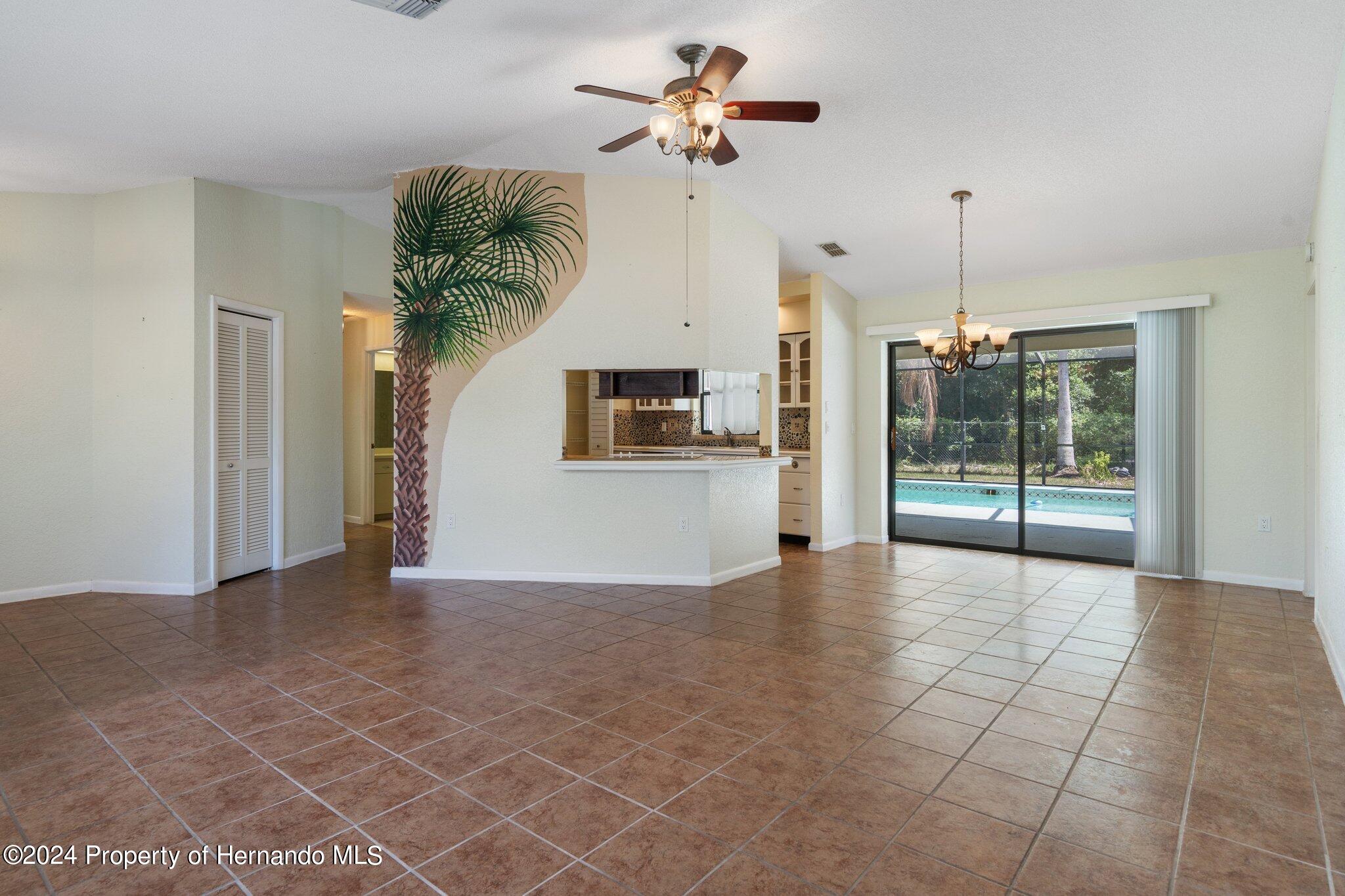 9290 Eldridge Road Spring Hill, FL 34608 - Photo 9 of 55 a view of a kitchen with a sink and a chandelier fan