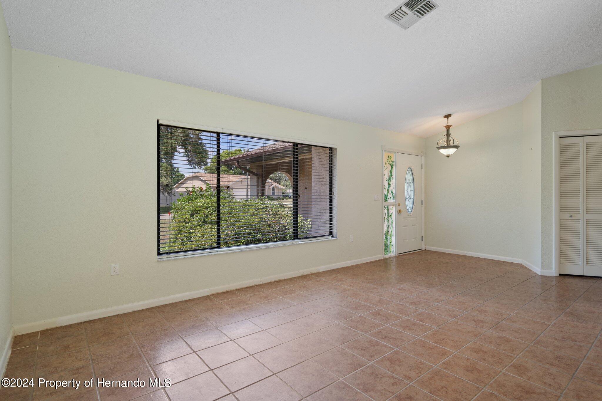 9290 Eldridge Road Spring Hill, FL 34608 - Photo 10 of 55 an empty room with windows and closet