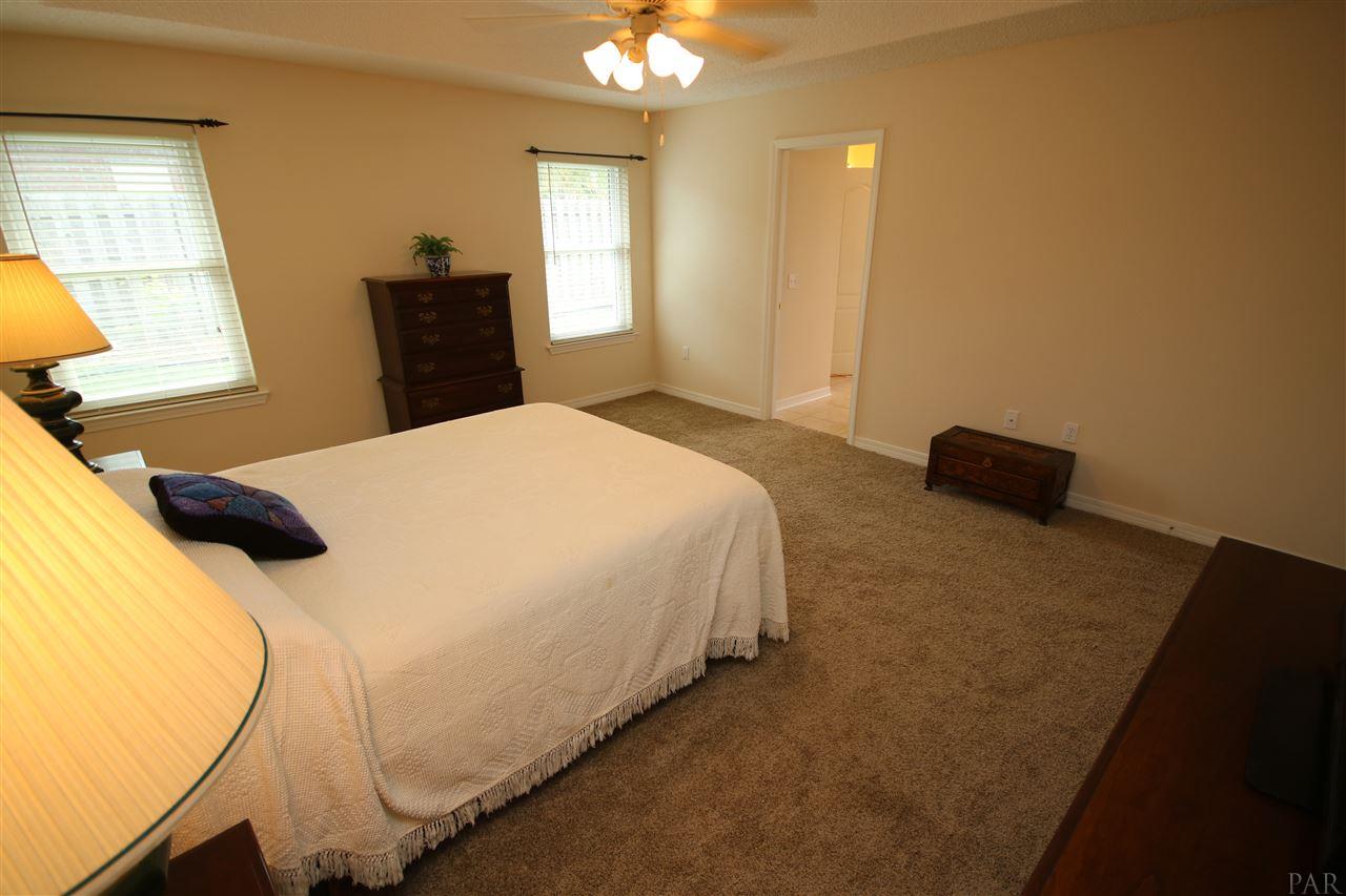 4916 Pineview Ridge Road Pace, FL 32571 - Photo 34 of 50 bath thru door ahead. Neutral paint throughout.